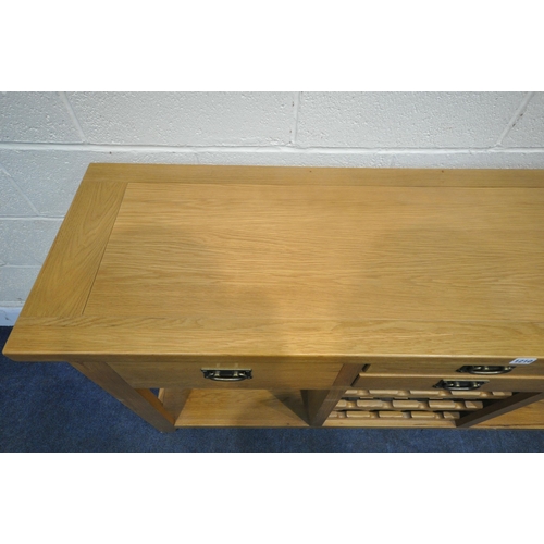 1210 - A SOLID OAK SIDEBOARD, fitted with an arrangement of four drawers and a central three tier wine rack... 