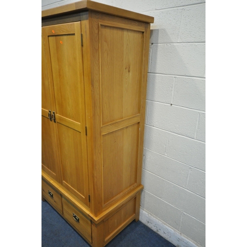 1217 - A SOLID OAK DOUBLE DOOR WARDROBE, with two drawers, width 110cm x depth 60cm x height 191cm (conditi... 