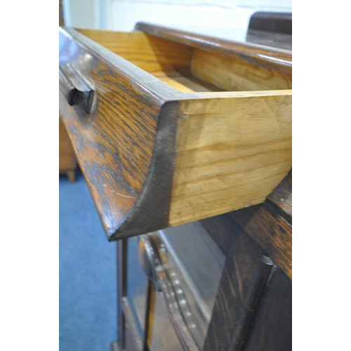 1226 - AN EARLY 20TH CENTURY OAK BOOKCASE, with two drawers, above two glazed doors, enclosing three adjust... 