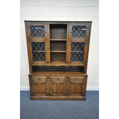 1243 - A 20TH CENTURY OAK DRESSER, the top fitted with an arrangement of lead glazed doors and shelving, th... 