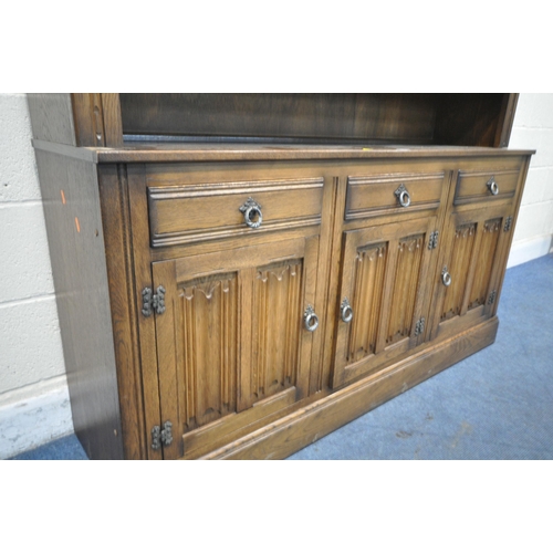 1243 - A 20TH CENTURY OAK DRESSER, the top fitted with an arrangement of lead glazed doors and shelving, th... 