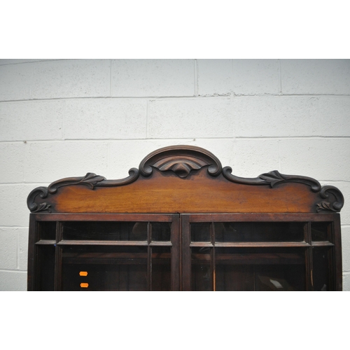 1254 - A VICTORIAN FLAME MAHOGANY BOOKCASE, the top with two glazed doors, enclosing three fixed shelves, t... 