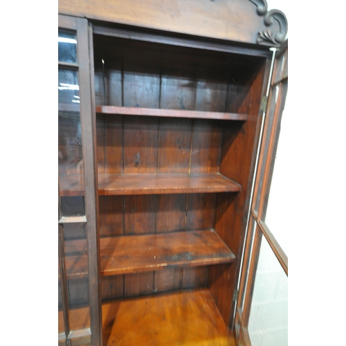 1254 - A VICTORIAN FLAME MAHOGANY BOOKCASE, the top with two glazed doors, enclosing three fixed shelves, t... 