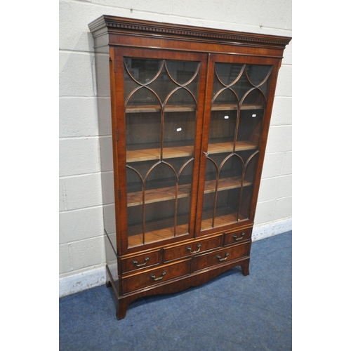 1262 - A 20TH CENTURY MAHOGANY BOOKCASE, the double astragal glazed doors enclosing three adjustable shelve... 