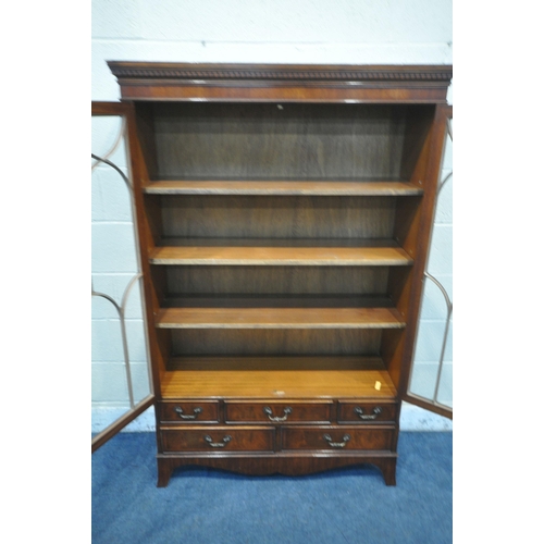 1262 - A 20TH CENTURY MAHOGANY BOOKCASE, the double astragal glazed doors enclosing three adjustable shelve... 