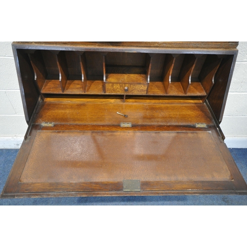 1263 - A 20TH CENTURY OAK BUREAU BOOKCASE, the top with double glazed doors, enclosing three adjustable she... 