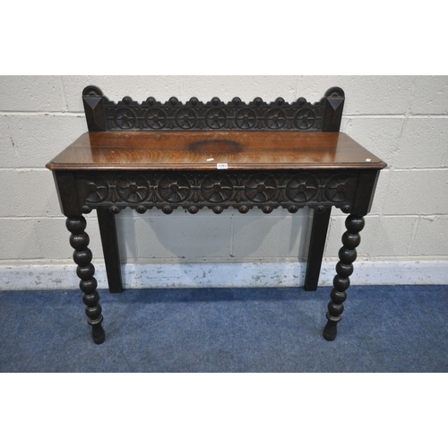 1267 - A LATE 29TH/EARLY 20TH CENTURY OAK SIDE TABLE, with raised back and single frieze drawer, both carve... 