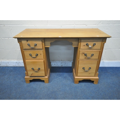 1269 - A MODERN PINE KNEE HOLE DESK, fitted with two banks of three drawers, on bracket feet, width 123cm x... 