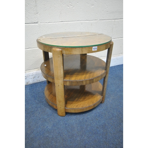 1272 - AN ART DECO WALNUT THREE TIER CIRCULAR OCCASIONAL TABLE, the top surface quarter veneered, with a gl... 