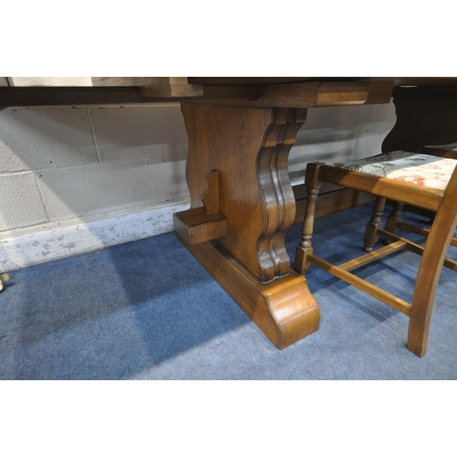 1283 - A SOLID OAK RECTANGULAR DINING TABLE, with two additional leaves, on trestle legs, united by a block... 