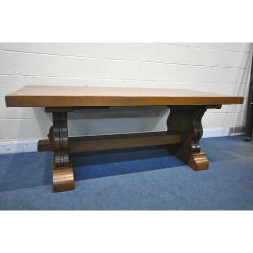 1283 - A SOLID OAK RECTANGULAR DINING TABLE, with two additional leaves, on trestle legs, united by a block... 