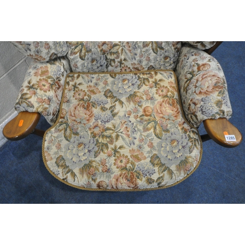 1285 - A 20TH CENTURY OAK FRAMED ARMCHAIR, with floral upholstery, width 83cm x depth 85cm x height 88cm (c... 