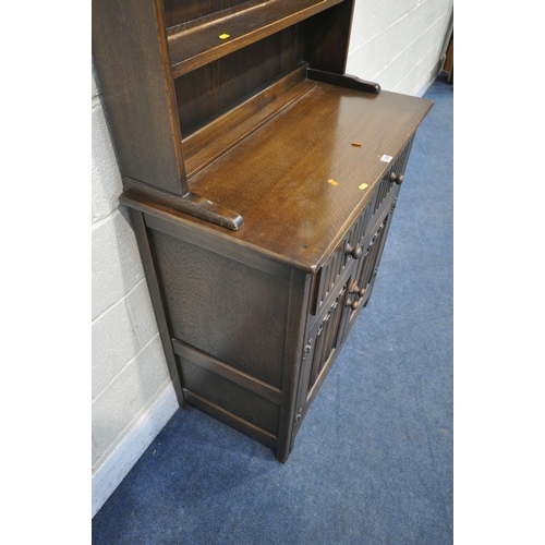 1289 - A 20TH CENTURY OAK DRESSER, the arched top with a two tier plate rack, on a base with two drawers ov... 