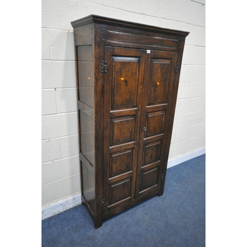 1292 - A REPRODUCTION SOLID OAK HALL ROBE, with double panelled doors, enclosing a single shelf and four co... 