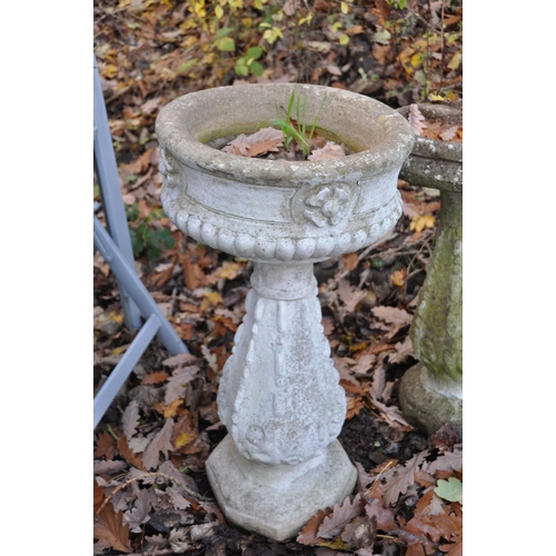 1002 - A WEATHERED COMPOSITE PLANTER, on a tall column, diameter 39cm x height 72cm, and a composite bird b... 