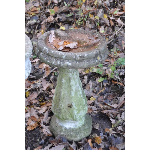 1002 - A WEATHERED COMPOSITE PLANTER, on a tall column, diameter 39cm x height 72cm, and a composite bird b... 