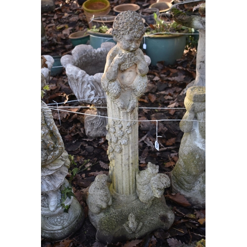 1018 - A WEATHERED COMPOSITE GARDEN FIGURE OF CHERUB ON A REEDED PILLAR, height 86c, along with another com... 