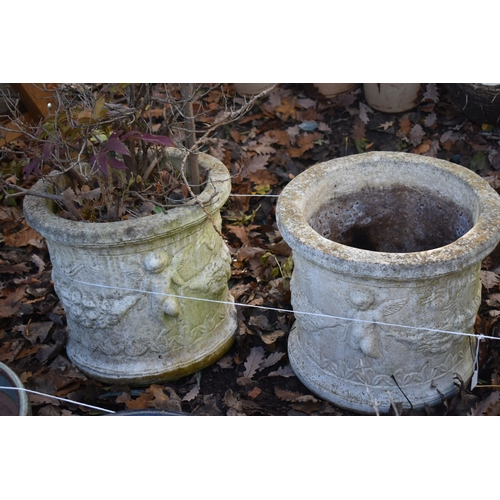 1019 - A SET OF THREE WEATHERED COMPOSITE PLANTERS, with cherubs to the side, diameter 44cm x height 39cm (... 