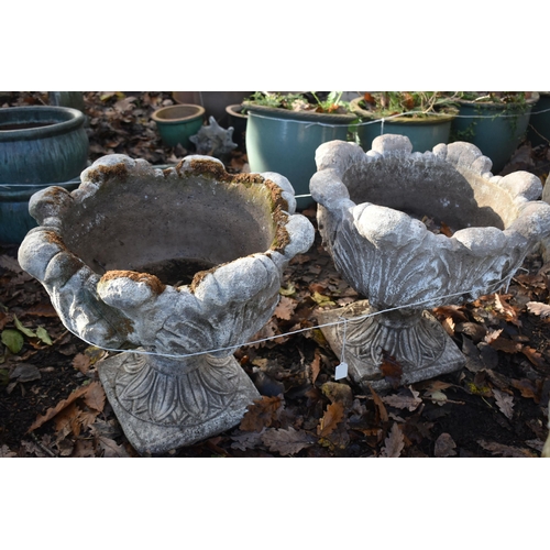 1021 - A PAIR OF WEATHERED COMPOSITE ACANTHUS LEAF PLANTERS, on an attached base, diameter 49cm x height 45... 