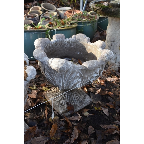 1021 - A PAIR OF WEATHERED COMPOSITE ACANTHUS LEAF PLANTERS, on an attached base, diameter 49cm x height 45... 