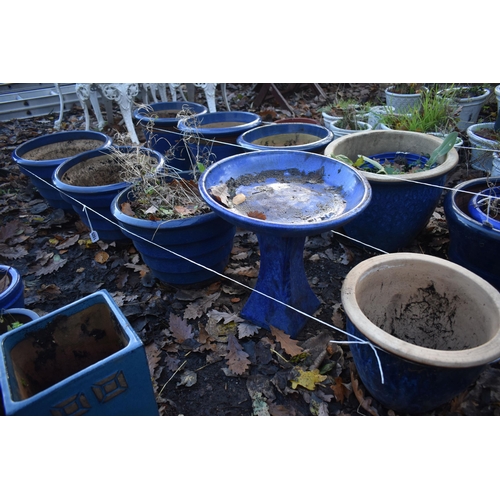 1025 - A SET OF THREE BLUE GLAZED PLANT POTS, diameter 38cm x height 28cm, a blue glazed bird bath, and ano... 