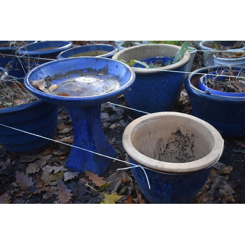 1025 - A SET OF THREE BLUE GLAZED PLANT POTS, diameter 38cm x height 28cm, a blue glazed bird bath, and ano... 