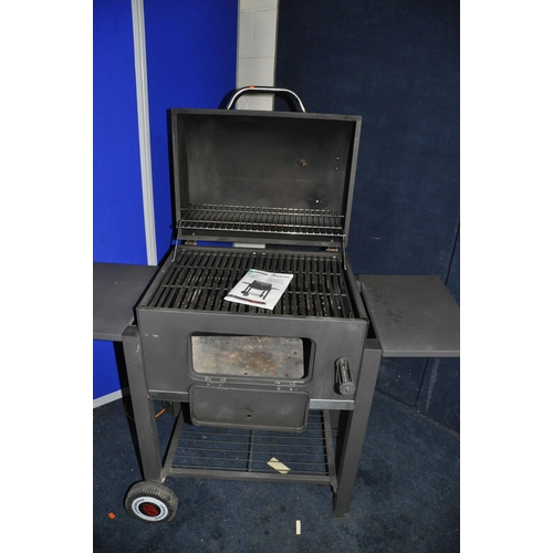 1075 - A LANDMANN SOLID FUEL BARBECUE with domed lid, temperature gauge, height adjustable fuel tray, under... 