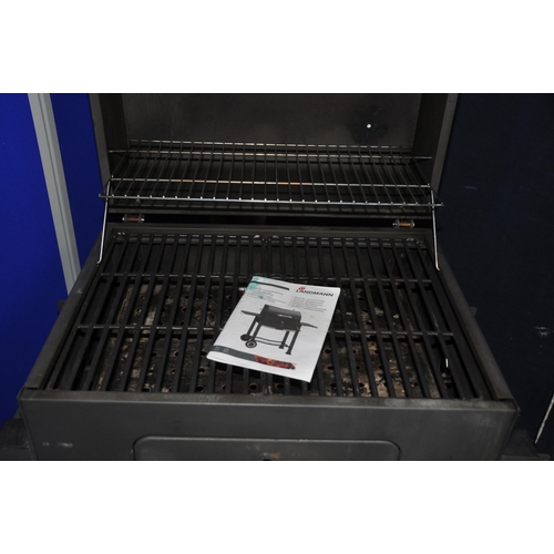 1075 - A LANDMANN SOLID FUEL BARBECUE with domed lid, temperature gauge, height adjustable fuel tray, under... 