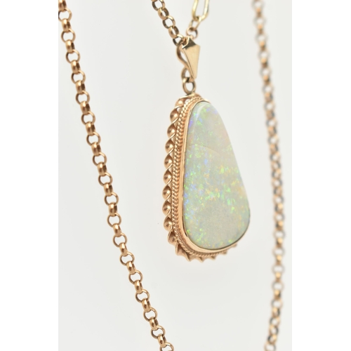 15 - AN OPAL PENDANT AND CHAIN, the triangular opal within a collet and double rope twist surround, suspe... 