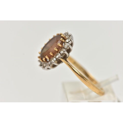 19 - AN 18CT GOLD SMOKY QUARTZ AND DIAMOND CLUSTER RING, the oval smoky quartz within a brilliant cut dia... 