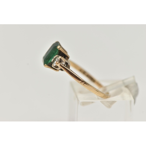 24 - A 9CT GOLD EMERALD AND DIAMOND RING, designed as a central emerald cut emerald in a four claw settin... 