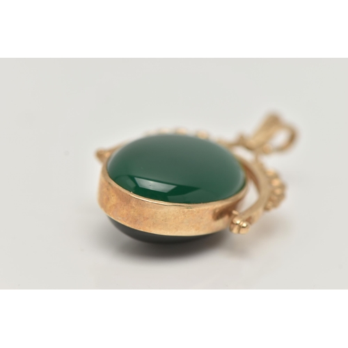 26 - A 9CT GOLD SWIVEL FOB, the oval fob set with an onyx and dyed chalcedony cabochon, to the scallop de... 