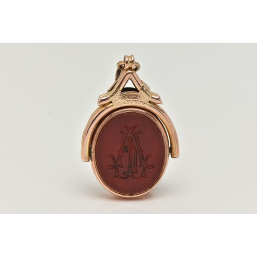 27 - AN EARLY 20TH CENTURY SWIVEL FOB, the oval swivel fob set with a carnelian panel to one side engrave... 