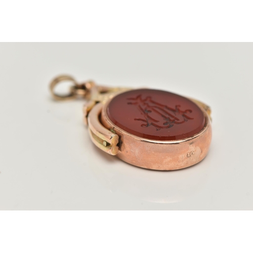 27 - AN EARLY 20TH CENTURY SWIVEL FOB, the oval swivel fob set with a carnelian panel to one side engrave... 