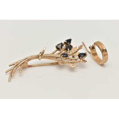 48 - A 9CT GOLD BROOCH AND A SINGLE EARRING, the brooch of a floral spray design set with pear cut deep b... 