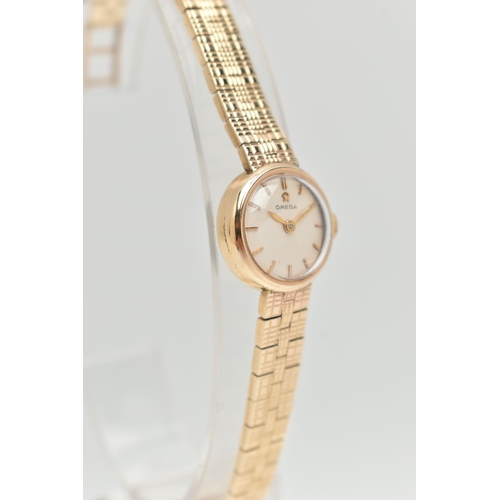 67 - A LADIES 9CT GOLD 'OMEGA' WRISTWATCH, manual wind, round silvered dial signed 'Omega', baton markers... 