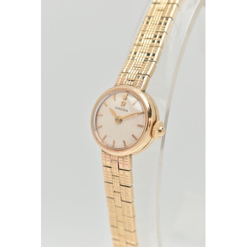 67 - A LADIES 9CT GOLD 'OMEGA' WRISTWATCH, manual wind, round silvered dial signed 'Omega', baton markers... 