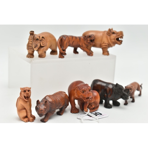 100 - EIGHT 20TH CENTURY CARVED TREEN NETSUKE, carved as rhinos, an elephant, tiger and other large cats, ... 