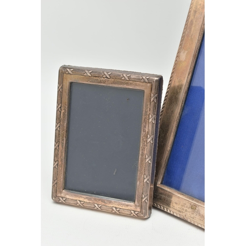 113 - TWO SILVER PHOTO FRAMES, the first of a rectangular form, approximate outer measurements 23cm x 18.3... 