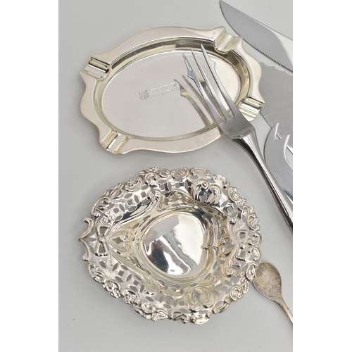 117 - A SELECTION OF SILVERWARE, to include a late Victorian decorative embossed silver pin dish with hear... 