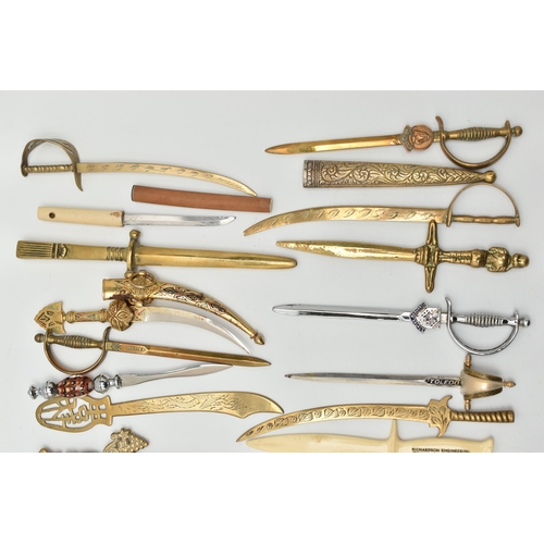 128 - THIRTY SEVEN LETTER OPENERS IN THE FORM OF SWORDS / DAGGERS, including a horn handled white metal ex... 