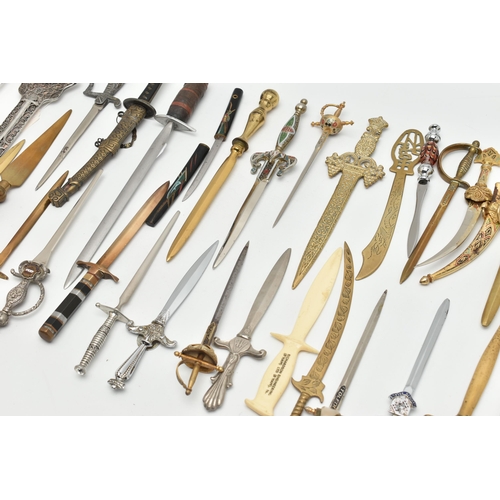 128 - THIRTY SEVEN LETTER OPENERS IN THE FORM OF SWORDS / DAGGERS, including a horn handled white metal ex... 