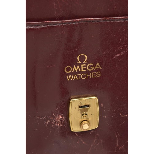 134 - AN 'OMEGA' BURGUNDY LEATHER DOCUMENTATION FOLDER, large rectangular wallet with slide release clasp,... 