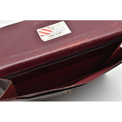 134 - AN 'OMEGA' BURGUNDY LEATHER DOCUMENTATION FOLDER, large rectangular wallet with slide release clasp,... 