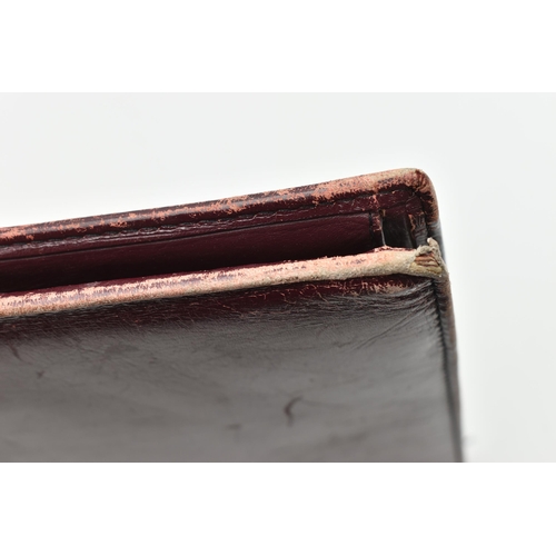 134 - AN 'OMEGA' BURGUNDY LEATHER DOCUMENTATION FOLDER, large rectangular wallet with slide release clasp,... 