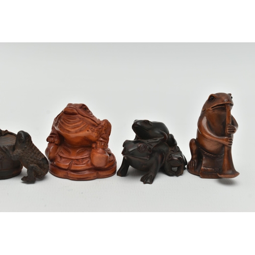 91 - SIX 20TH CENTURY CARVED TREEN NETSUKE, all in the form of frogs / toads, three with inset eyes, four... 