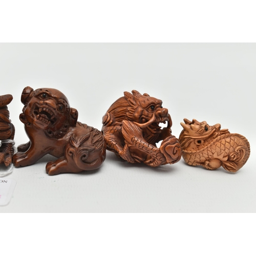 94 - FOUR 20TH CENTURY CARVED TREEN NETSUKE AND TWO OKIMONO, all in the form of dragons, all with inset e... 