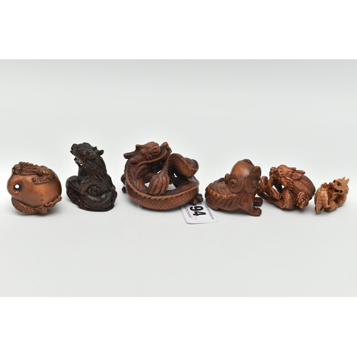 94 - FOUR 20TH CENTURY CARVED TREEN NETSUKE AND TWO OKIMONO, all in the form of dragons, all with inset e... 