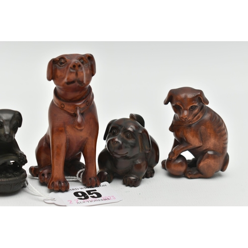 95 - FOUR 20TH CENTURY CARVED TREEN NETSUKE AND TWO OKIMONO, all in the form of dogs, five with inset eye... 