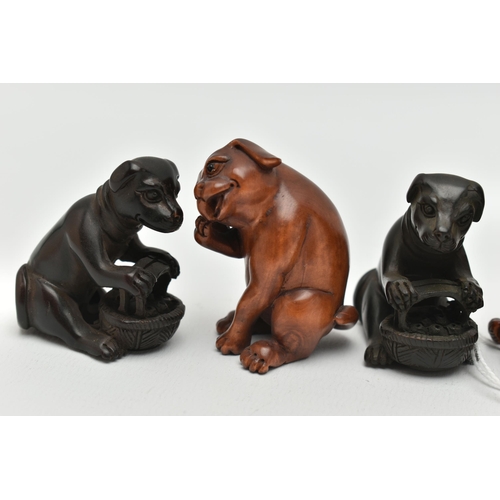 95 - FOUR 20TH CENTURY CARVED TREEN NETSUKE AND TWO OKIMONO, all in the form of dogs, five with inset eye... 